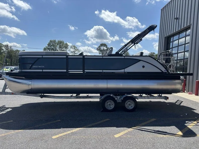 The Image of 2026 Godfrey SWEETWATER 2286 SFL pontoon boat on trailer, parked outdoors. - 0