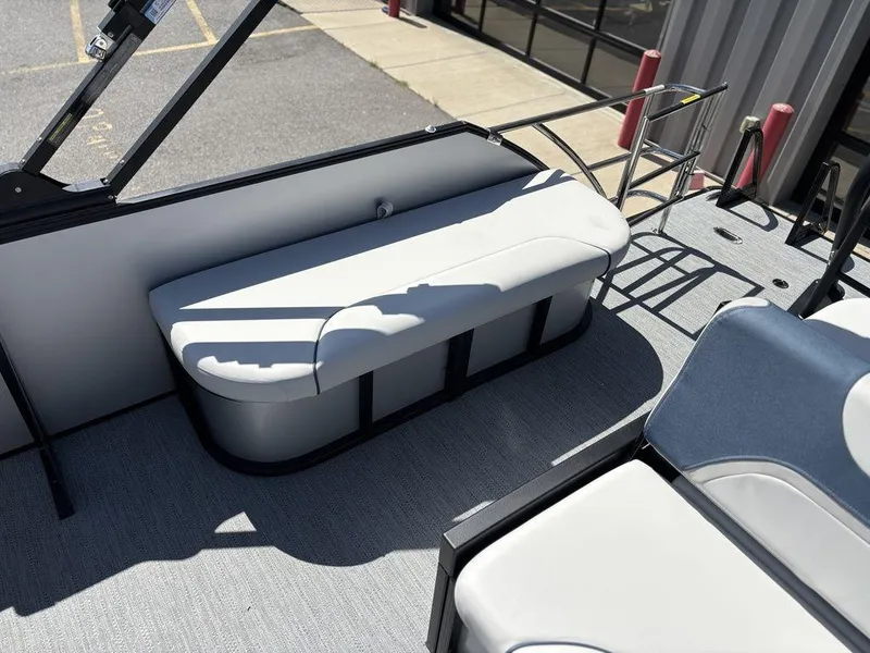 Slide: The Image of 2026 Godfrey SWEETWATER 2286 SFL boat interior with white seating and ladder. - 14