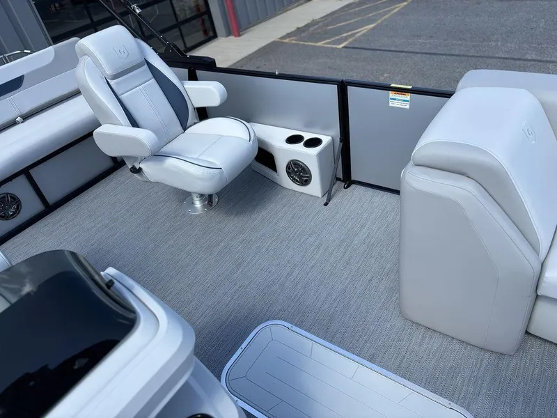 Slide: The Image of 2026 Godfrey SWEETWATER 2286 SFL boat interior with seating and cup holders. - 15