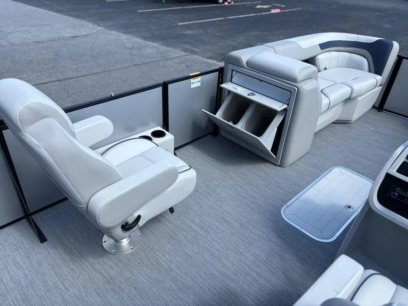 Slide: The Image of 2026 Godfrey SWEETWATER 2286 SFL boat interior with gray seating and storage compartments. - 17