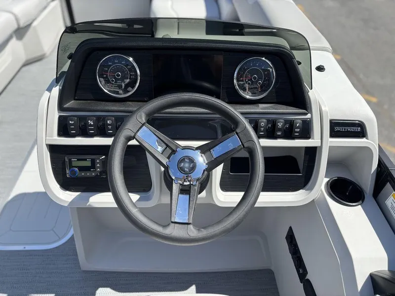 Slide: The Image of Steering console of 2026 Godfrey SWEETWATER 2286 SFL boat with gauges and controls. - 19
