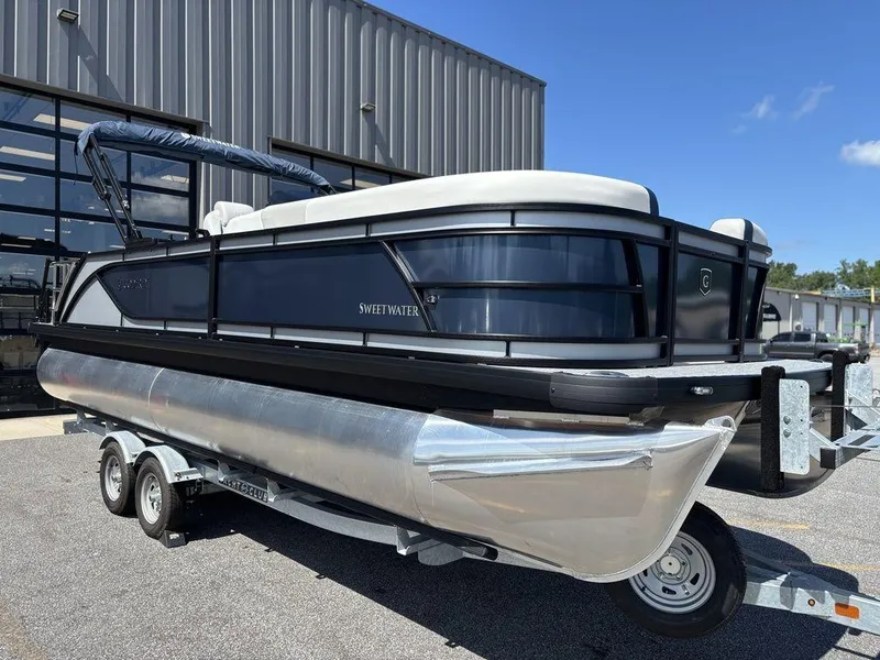 Slide: The Image of 2026 Godfrey SWEETWATER 2286 SFL pontoon boat on trailer, parked outdoors. - 5