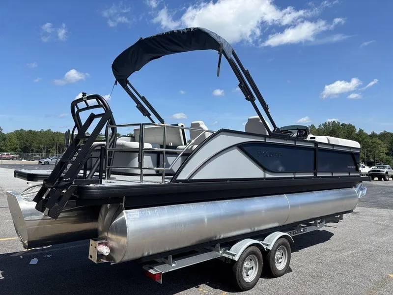Slide: The Image of 2026 Godfrey SWEETWATER 2286 SFL pontoon boat on trailer under blue sky. - 8