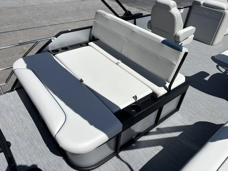 Slide: The Image of 2026 Godfrey SWEETWATER 2286 SFL boat interior with white cushioned seating and cup holders. - 9
