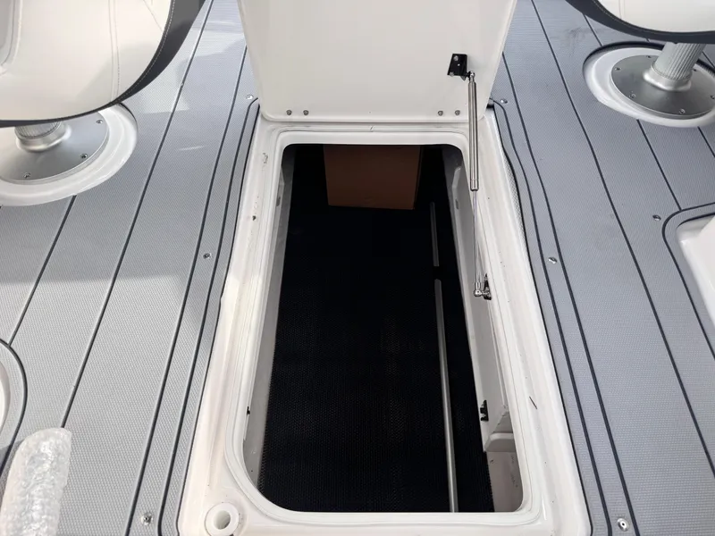 Slide: The Image of Open storage compartment on 2025 Chaparral 307 SSX boat deck. - 13