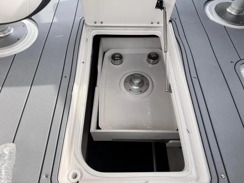 Slide: The Image of Open storage compartment on 2025 Chaparral 307 SSX boat deck. - 15