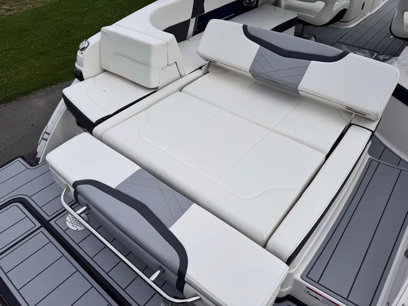Slide: The Image of 2025 Chaparral 307 SSX boat with luxurious white seating and sleek design. - 23