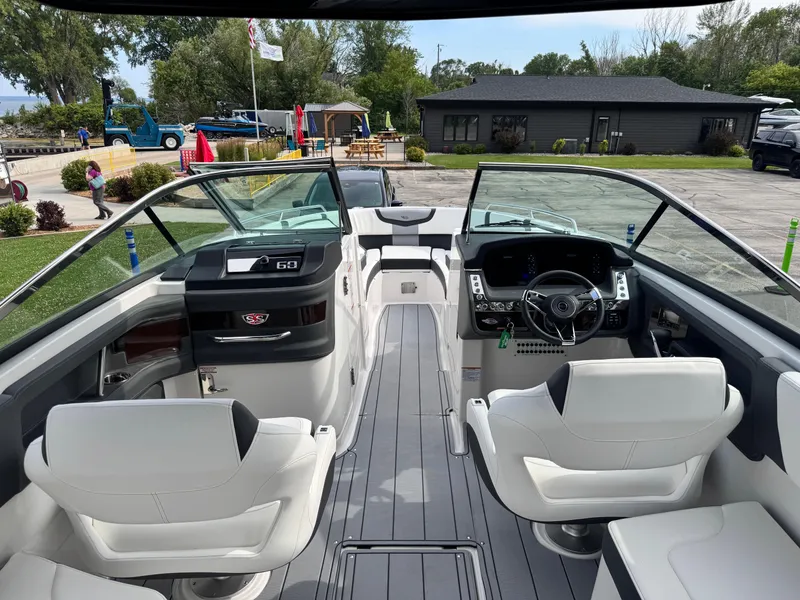 Slide: The Image of 2025 Chaparral 307 SSX boat interior with modern dashboard and white seating. - 25