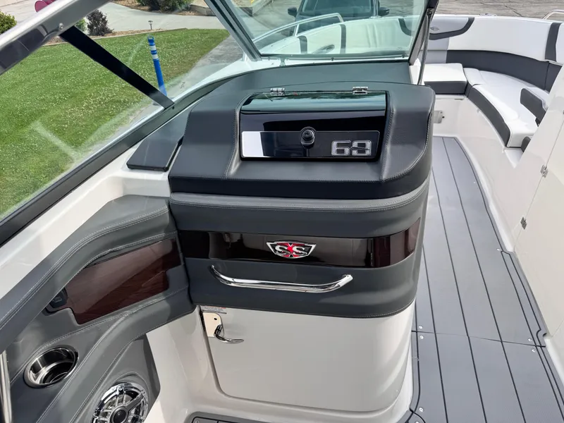 Slide: The Image of 2025 Chaparral 307 SSX boat interior with sleek dashboard and seating area. - 26