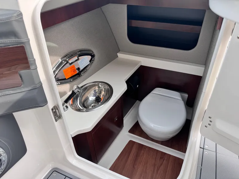 Slide: The Image of 2025 Chaparral 307 SSX boat interior bathroom with sink and toilet. - 27