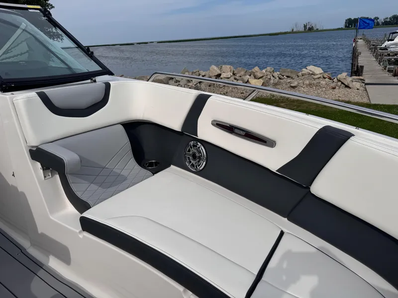Slide: The Image of 2025 Chaparral 307 SSX boat interior with sleek seating by the water. - 30