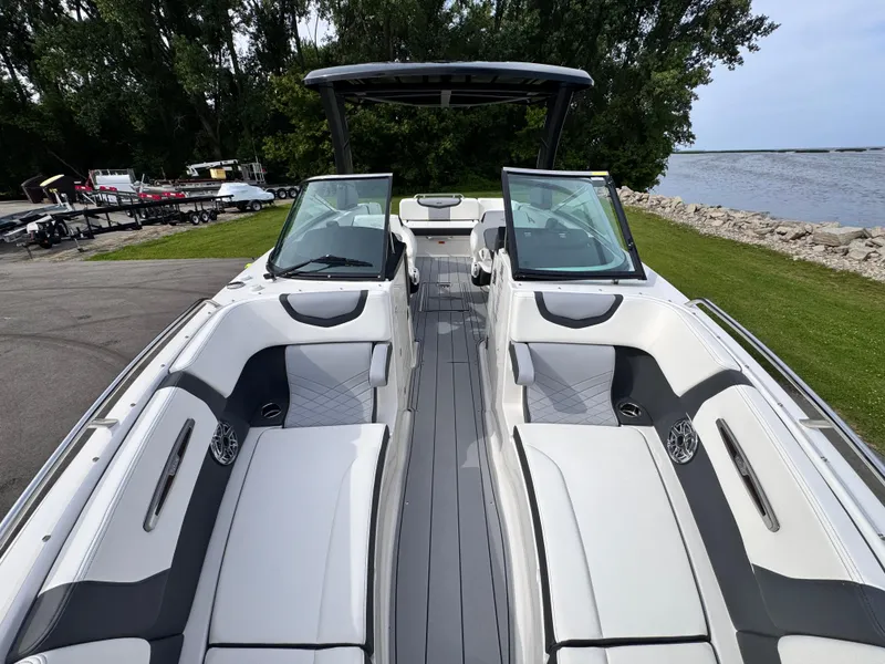 Slide: The Image of 2025 Chaparral 307 SSX boat interior with sleek seating and modern design by the water. - 32