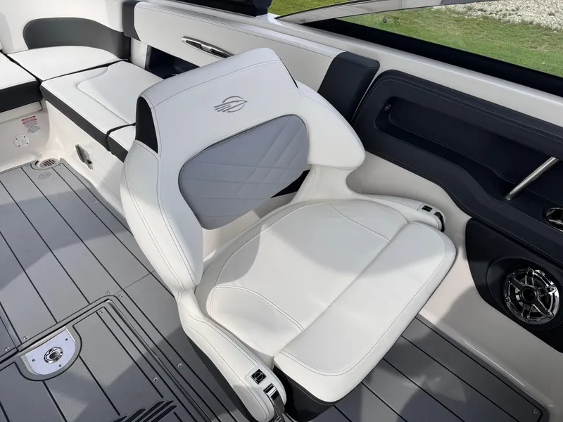 Slide: The Image of 2025 Chaparral 307 SSX boat interior with white seating and modern design. - 35