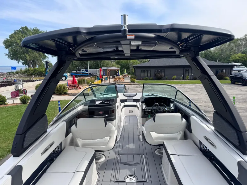 Slide: The Image of 2025 Chaparral 307 SSX boat interior with sleek seating and modern dashboard. - 5