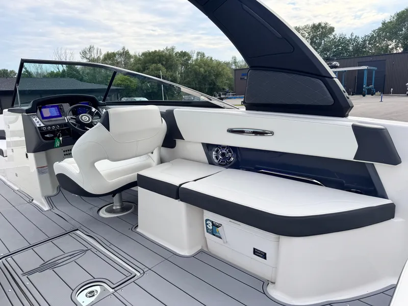 Slide: The Image of 2025 Chaparral 307 SSX boat interior with sleek seating and modern dashboard. - 6
