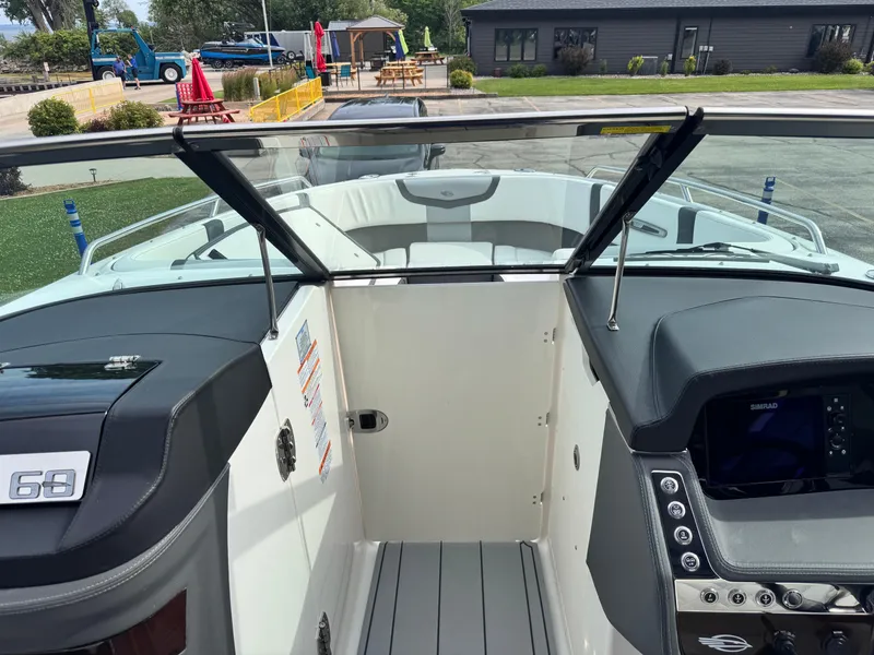 Slide: The Image of 2025 Chaparral 307 SSX boat interior with open windshield and modern dashboard controls. - 9