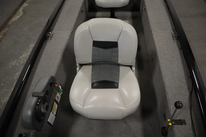 Slide: The Image of 2018 Tracker Panfish 16 boat interior with gray seating and steering controls. - 20