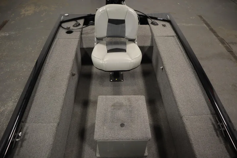 Slide: The Image of 2018 Tracker Panfish 16 boat interior with gray seating and carpeted flooring. - 23