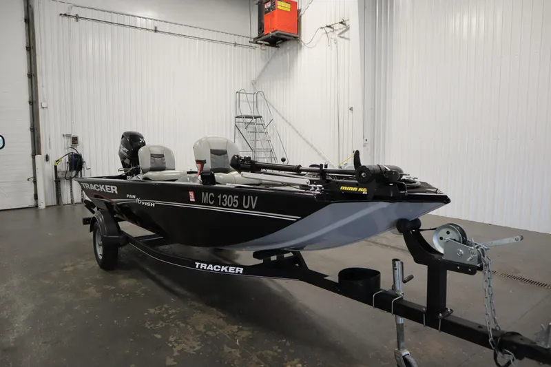 Slide: The Image of 2018 Tracker Panfish 16 boat in a garage, featuring a sleek black design. - 3