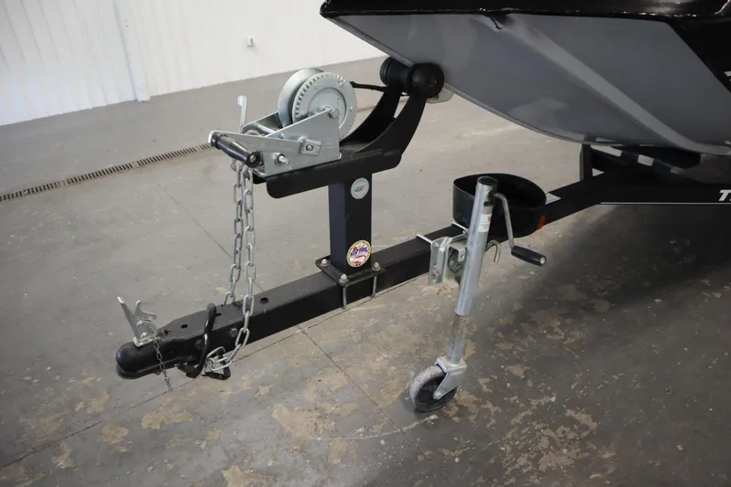 Slide: The Image of Trailer hitch and winch of 2018 Tracker Panfish 16 boat in a garage setting. - 35