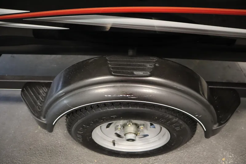 Slide: The Image of 2018 Tracker Panfish 16 trailer wheel with black fender and red stripe detailing. - 39