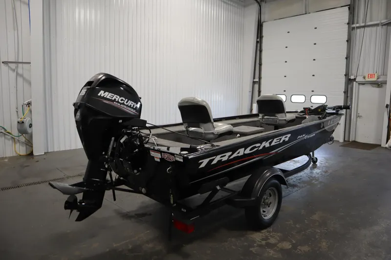 Slide: The Image of 2018 Tracker Panfish 16 boat with Mercury engine in a garage setting. - 5
