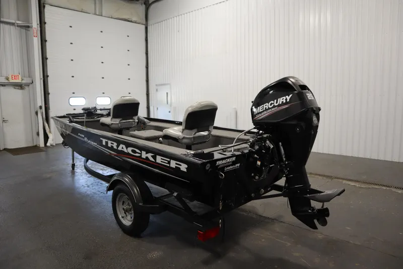 Slide: The Image of 2018 Tracker Panfish 16 boat with Mercury engine in a garage setting. - 7