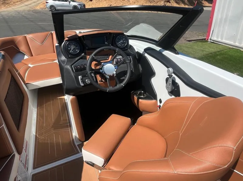 Slide: The Image of Interior of 2021 Supreme S 238 boat with tan leather seats and modern dashboard. - 16