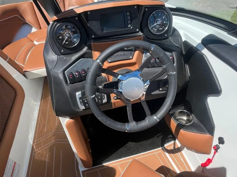 Slide: The Image of 2021 Supreme S 238 boat dashboard with steering wheel and gauges. - 17
