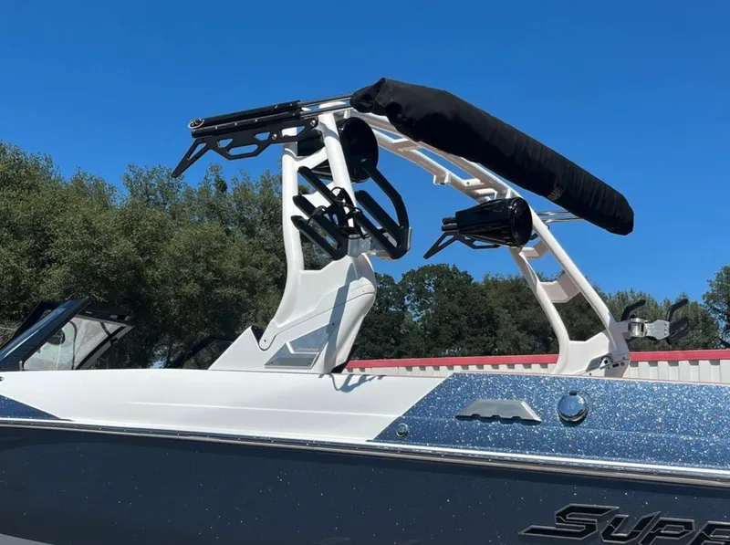 Slide: The Image of 2021 Supreme S 238 boat with wakeboard tower against clear blue sky. - 2