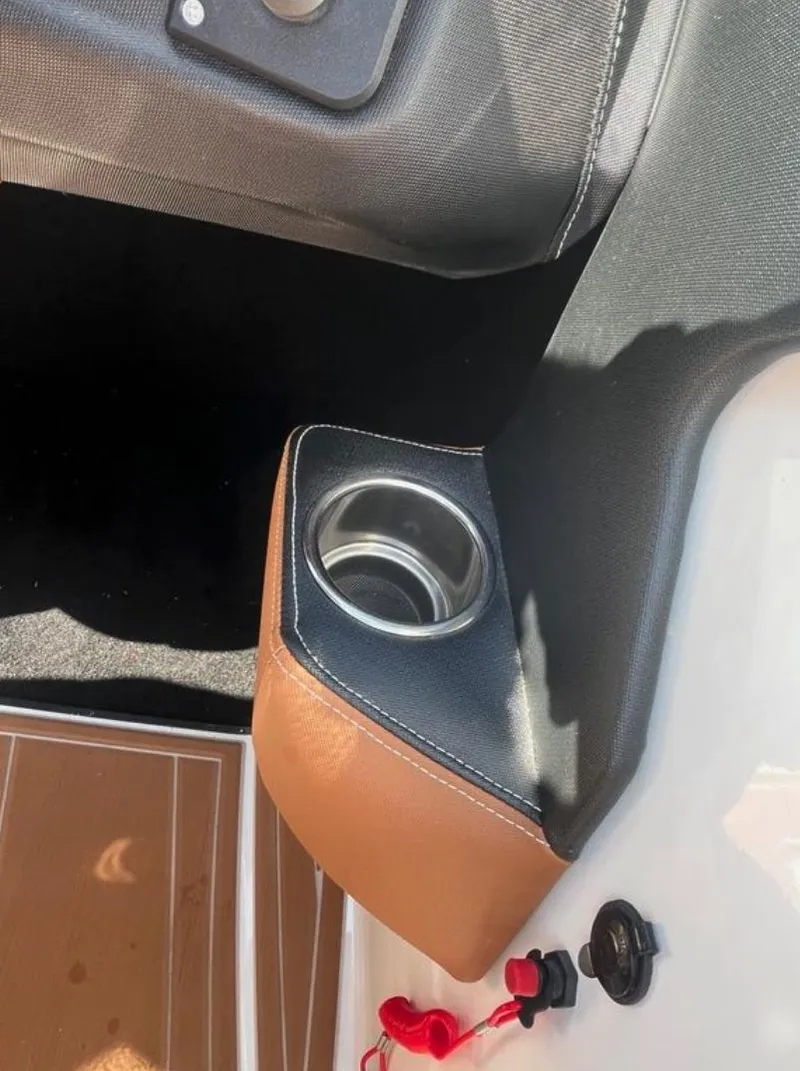 Slide: The Image of 2021 Supreme S 238 boat interior with cup holder and control panel. - 20