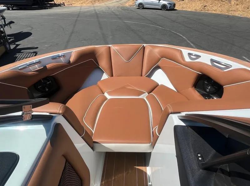 Slide: The Image of 2021 Supreme S 238 boat interior with brown leather seating and modern design. - 23