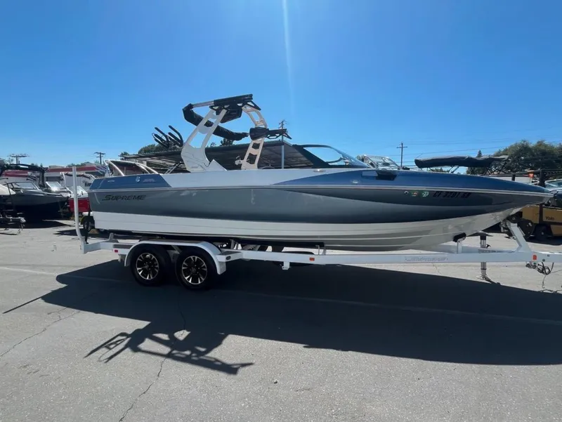 Slide: The Image of 2021 Supreme S 238 boat on trailer under clear blue sky. - 30