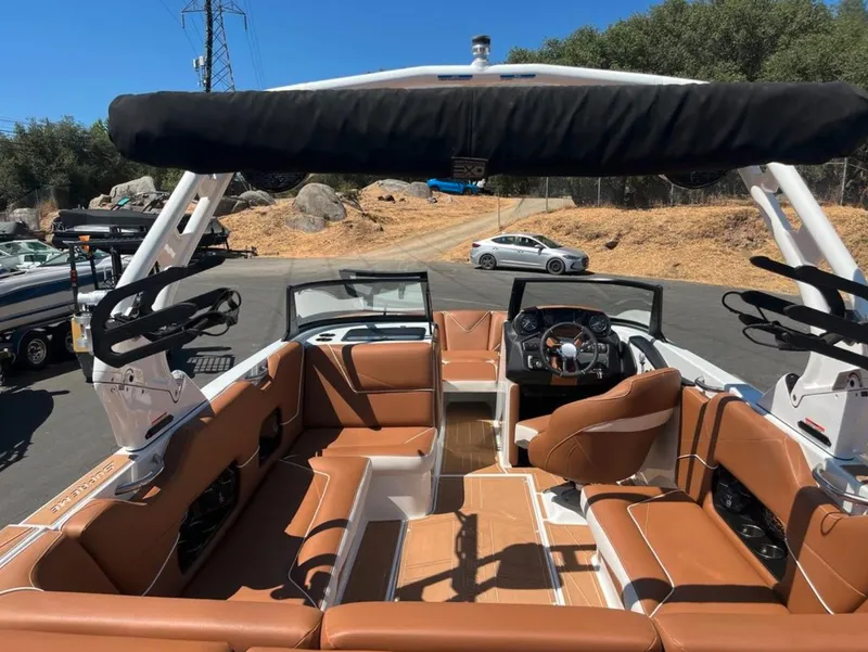 Slide: The Image of 2021 Supreme S 238 boat interior with brown seating and modern dashboard. - 5