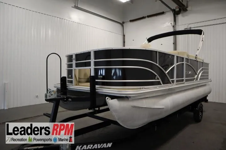 Slide: The Image of 2019 Sylvan 820 Mirage pontoon boat on trailer in indoor showroom. - 1