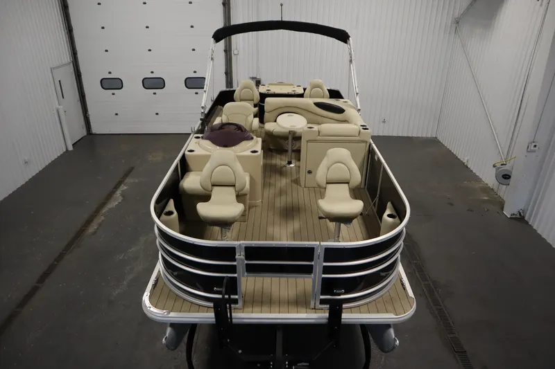 Slide: The Image of 2019 Sylvan 820 Mirage pontoon boat in a spacious indoor storage facility. - 10