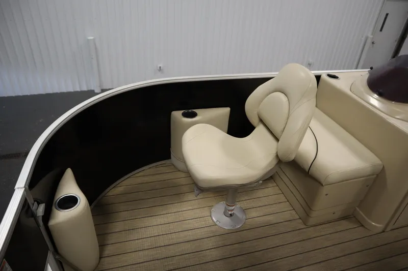 Slide: The Image of 2019 Sylvan 820 Mirage boat interior with beige seating and cup holders. - 13
