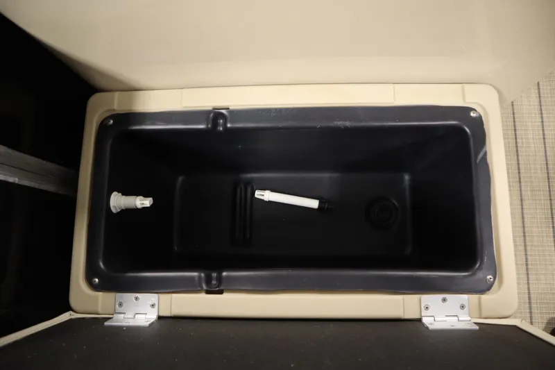 Slide: The Image of Storage compartment in a 2019 Sylvan 820 Mirage boat, featuring a black interior. - 15