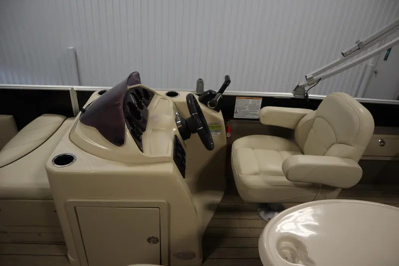 Slide: The Image of 2019 Sylvan 820 Mirage boat interior with steering console and beige seating. - 17