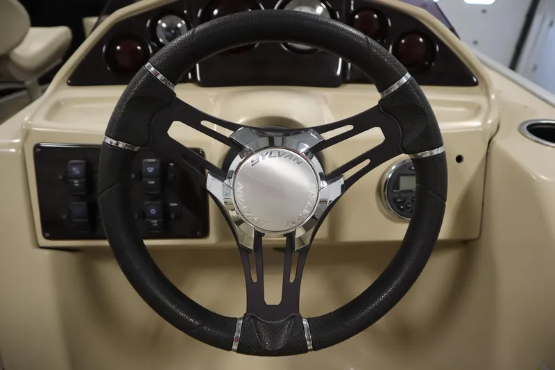 Slide: The Image of Steering wheel of 2019 Sylvan 820 Mirage boat, featuring control panel and dashboard. - 20