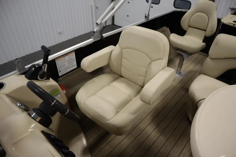 Slide: The Image of 2019 Sylvan 820 Mirage boat interior with beige seating and steering wheel. - 26