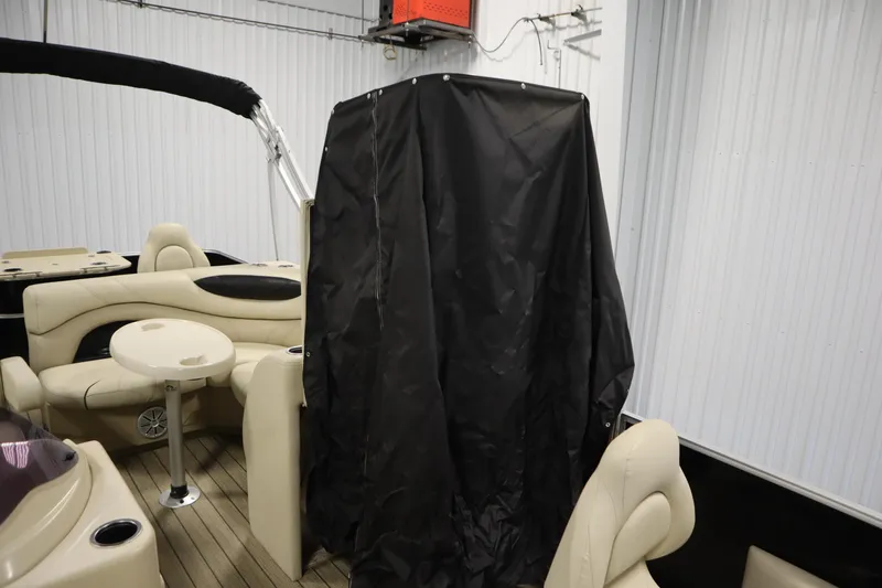 Slide: The Image of 2019 Sylvan 820 Mirage boat interior with beige seating and black cover. - 28