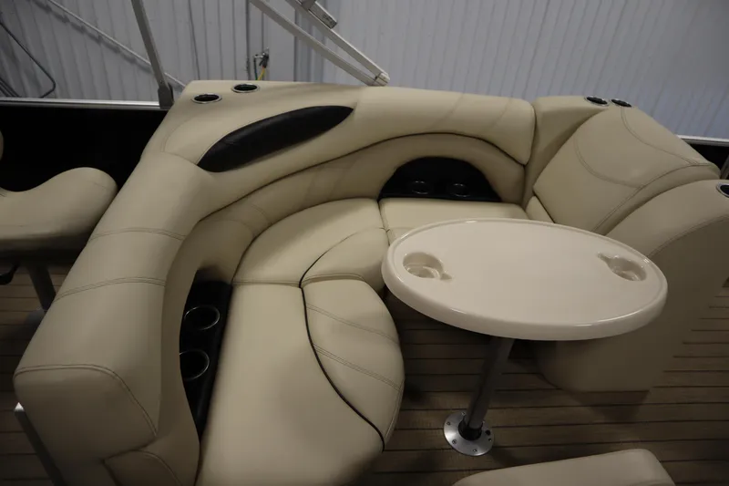 Slide: The Image of 2019 Sylvan 820 Mirage boat interior with beige seating and table. - 29