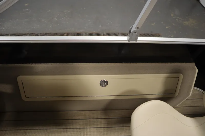 Slide: The Image of 2019 Sylvan 820 Mirage boat interior storage compartment with beige seating. - 34