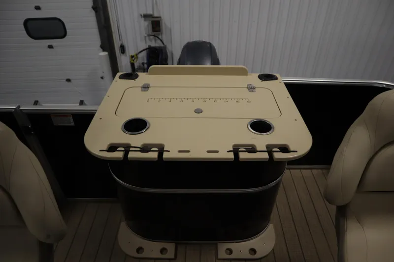 Slide: The Image of 2019 Sylvan 820 Mirage boat interior with beige seating and utility table. - 38