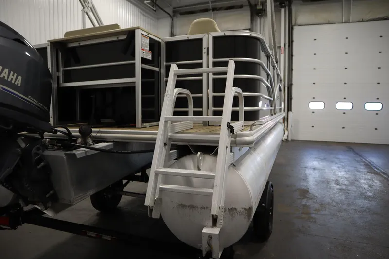 Slide: The Image of 2019 Sylvan 820 Mirage pontoon boat in a garage, featuring a Yamaha motor. - 41