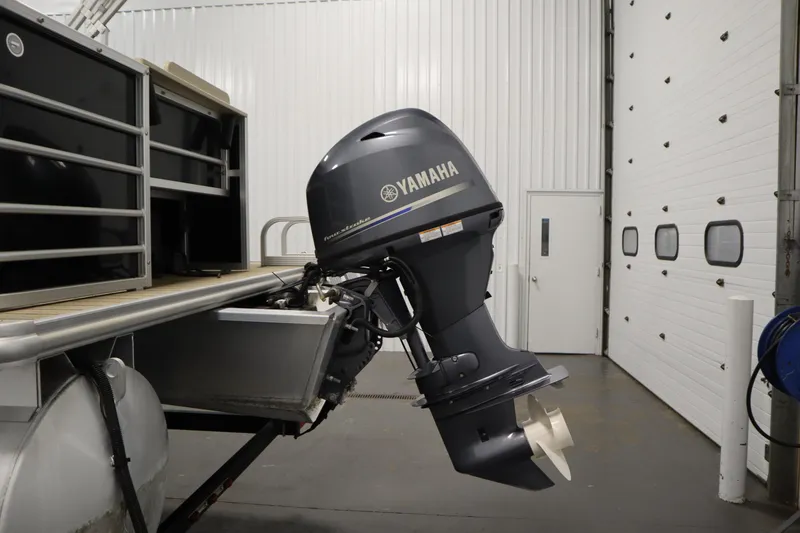 Slide: The Image of 2019 Sylvan 820 Mirage with Yamaha outboard motor in a garage setting. - 43