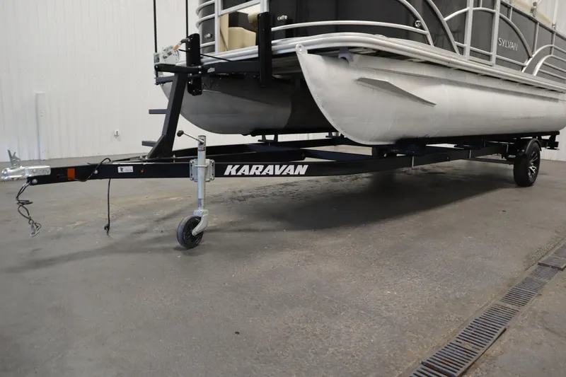 Slide: The Image of 2019 Sylvan 820 Mirage pontoon boat on Karavan trailer in indoor setting. - 47