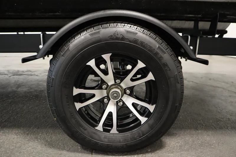 Slide: The Image of Close-up of a 2019 Sylvan 820 Mirage trailer wheel with black and silver rim. - 48