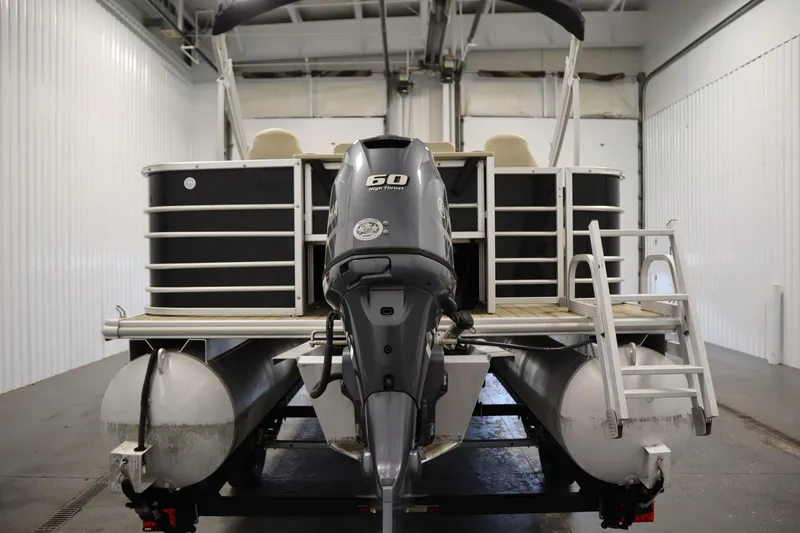 Slide: The Image of 2019 Sylvan 820 Mirage pontoon boat with 50 HP engine in a storage facility. - 7